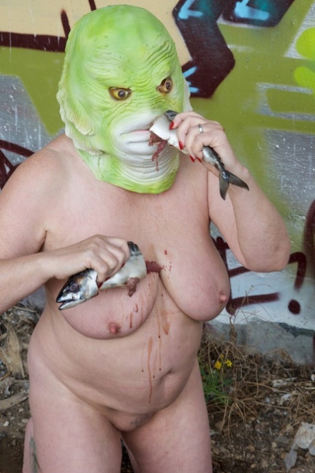 Speedy Bee, a naked British woman in disguise, consumes a fish while wearing her costume.