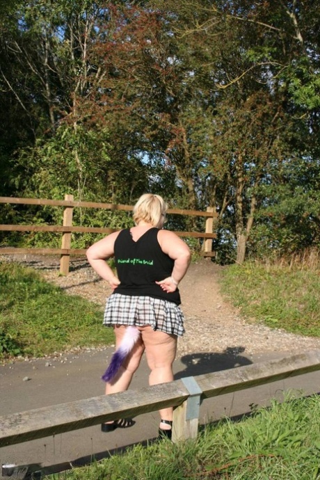 A blond UK blonde named Lexie Cummings displays her large buttock cap while outdoors.