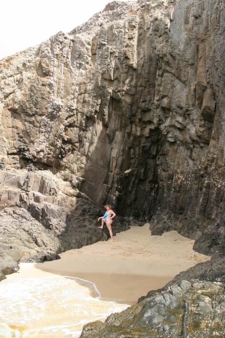 Despite her height, Curvy Claire, a slim British woman, loses all her breasts from her bikini by the sea.