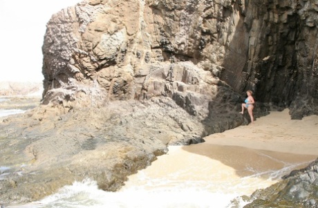 By the sea, Curvy Claire, a robust woman from Britain, exposes her breasts while wearing a bikini.