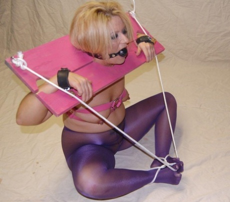 Ball gag: A white woman donning pink stockings while bottomless.