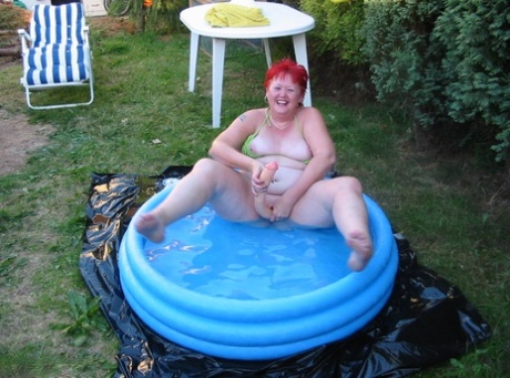 A wading pool is where the older redheaded BBW Valgasmic Exposed can be seen with a dildo.