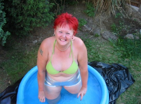 In a wading pool, an older man named BBW Valgasmic Exposed with redheaded heads enjoys playing with his dildo.