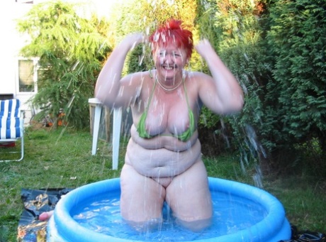 Older Redheaded BBW Valgasmic Exposed Plays With A Dildo In A Wading Pool