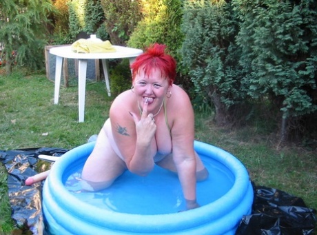 Older Redheaded BBW Valgasmic Exposed Plays With A Dildo In A Wading Pool
