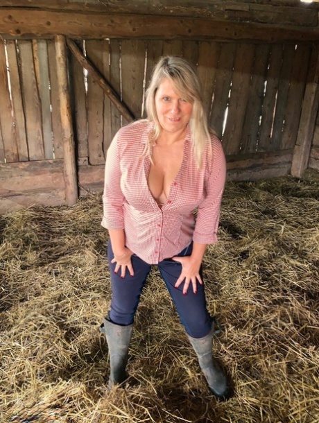 When overweight Sweet Susi is grazing on hay in the mow, she takes off her clothes and strips herself naked.