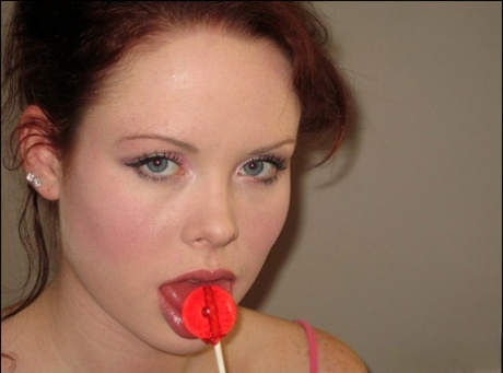 Young Redhead Lana Licks A Sucker While Wearing Pink Baby Doll Lingerie