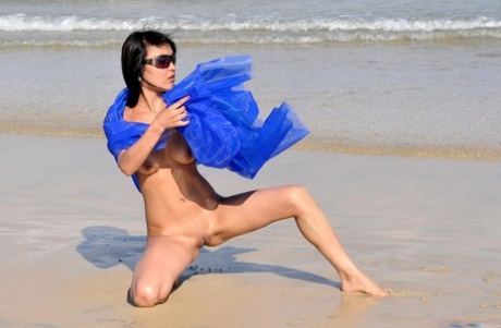 Dark-haired Girl Models For A Nude Shoot At The Beach In Sunglasses