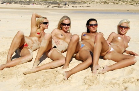 Caucasian Girls Wander A Beach While Wearing Nipple Pasties And Thongs