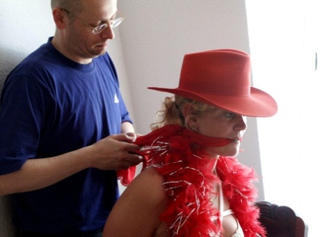 Prior to being cleaved gagged, a blonde girl is restrained on a chair.