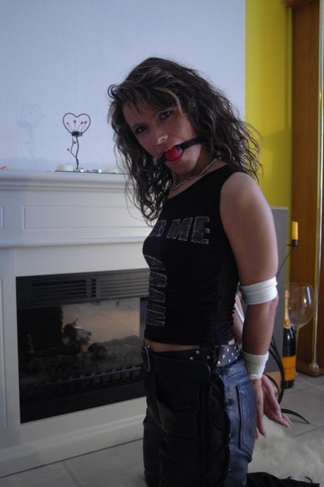 Caucasian Female Has Her Arms Tied Behind Her Back While Ball Gagged