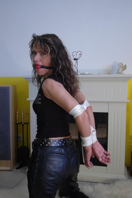 Caucasian Female Has Her Arms Tied Behind Her Back While Ball Gagged