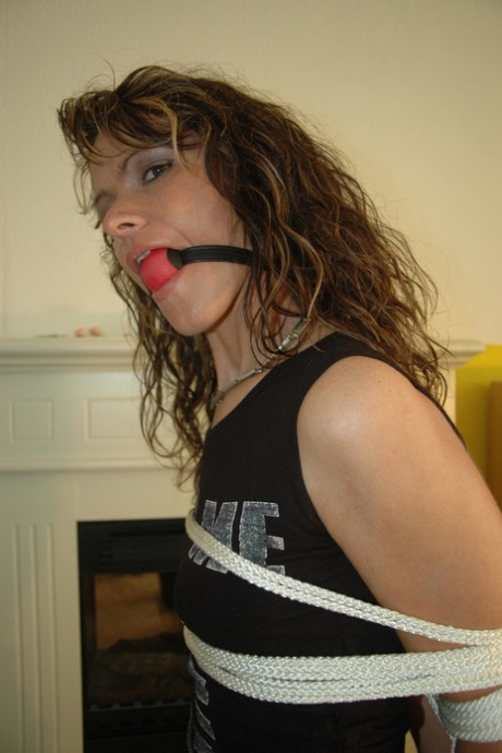 Caucasian Female Has Her Arms Tied Behind Her Back While Ball Gagged