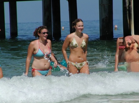 A group of younger females are filmed without anyone knowing, wading into the sea in their bikinis.