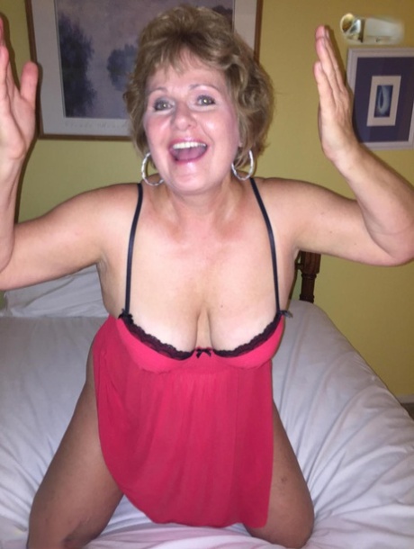 Older woman Busty Bliss exposed her large breast area on a bed, wearing only the top of a pant and bottom to show off her big busts.