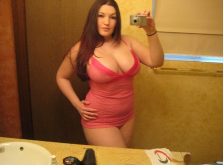 Her thick amateur physique is showcased in a mirror as she takes selfies.