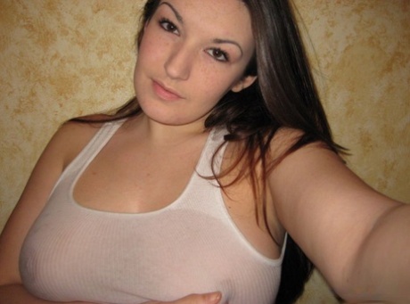 The Brunette amateur model, a wet tank top is used during non-nude self action shots.
