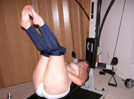 A mature woman named Devlynnţă displays her bellies and snort on her home gym equipment.