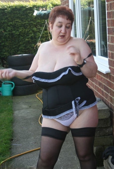 Outside her home, BBW Kinky, an older amateur, releases her large tits.