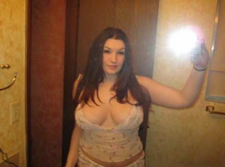 Pretty Amateur Exposes Her Large Breasts While Taking Self Shots In A Mirror