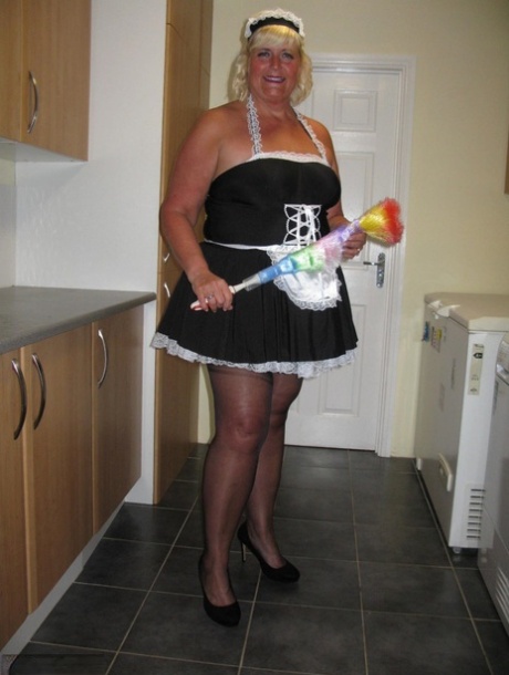 While working in a kitchen, the overweight blonde maid named Chrissy Uk exposes herself.