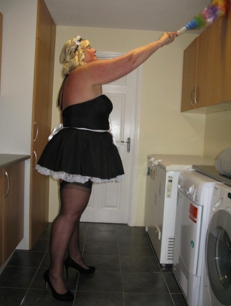During work in a kitchen, Chrissy Uk, an overweight blonde maid, exposes herself.