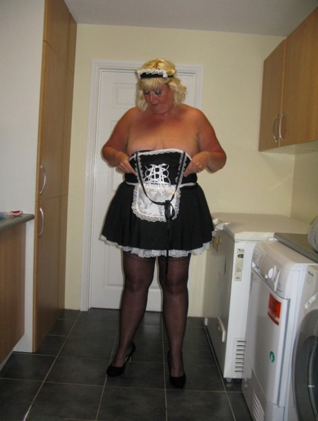 At work, Chrissy Uk, an overweight blonde maid who works as a front-dresser, exposes herself in a kitchen.
