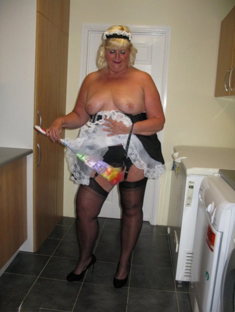 As she works in a kitchen, the overweight blonde maid named Chrissy Uk expose herself.