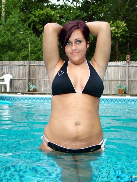 In a swimming pool, Roxy models a bikini for the first time as a brunette.