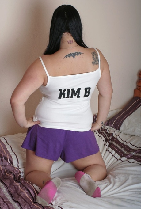 Shown here is the British plumper Kim B who proudly displays her large, natural breasts while sucking on candy.