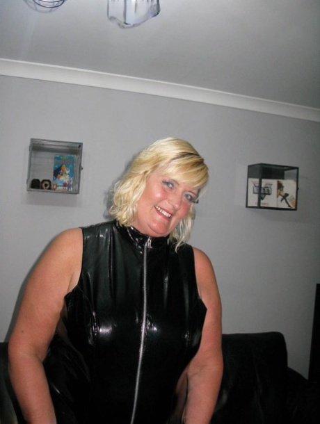 Chrissy Uk, an elderly and blonde amateur, releases her tits and wrists from latex wear.