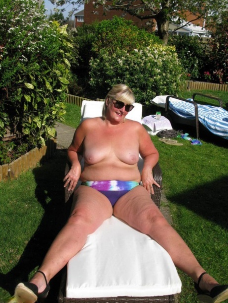 After being exposed in a yard sale, Chrissy Uk is seen having fun with her nude body and even pulls off the naked leg.