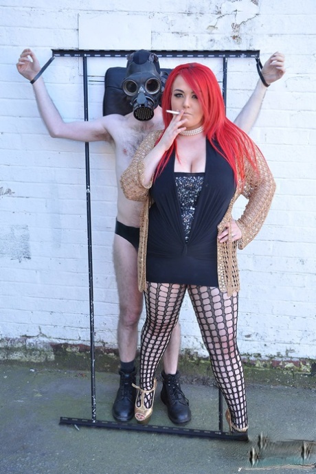 Fat Redhead Mistress Jemstone Tops A Submissive Man In An Outdoor Setting