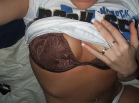 Sexy Blonde Lifts Up Her T-shirt To Show Her Belly Piercing And Bra
