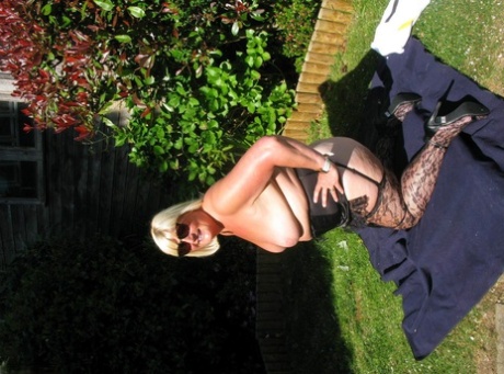 At home, Chrissy Uk, a mature woman who is blonde and fatty, exposes herself in nylon pants for a quick look.