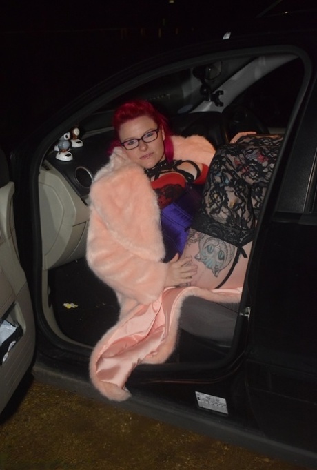 Amateur chick with dyed hair steps out of a vehicle to flash in lingerie