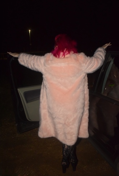 Amateur chick with dyed hair steps out of a vehicle to flash in lingerie