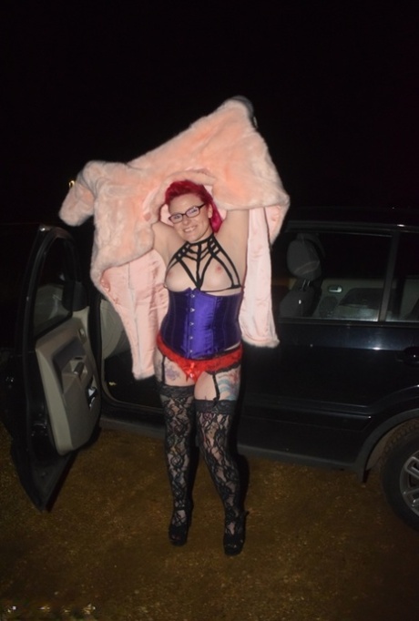 Amateur chick with dyed hair steps out of a vehicle to flash in lingerie