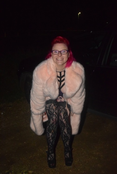 Amateur chick with dyed hair steps out of a vehicle to flash in lingerie