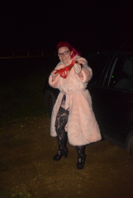 Amateur chick with dyed hair steps out of a vehicle to flash in lingerie