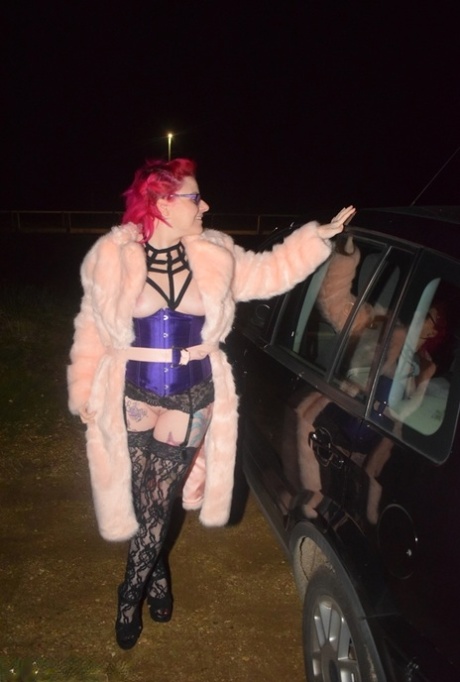 Amateur chick with dyed hair steps out of a vehicle to flash in lingerie