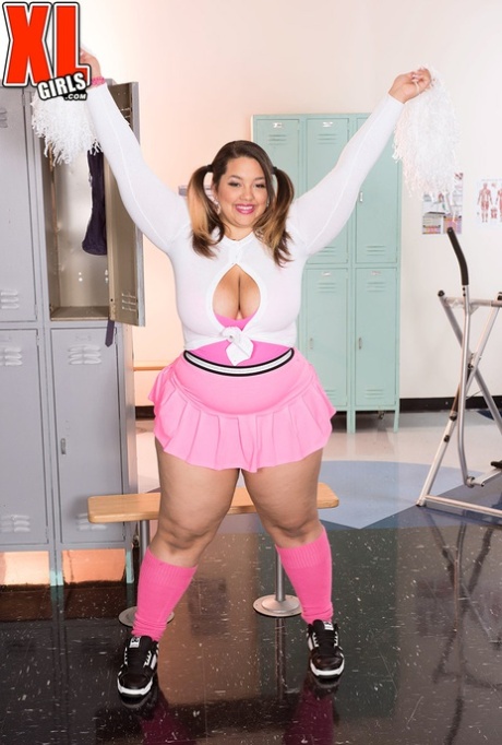 Chevy Cobain, a fat cheerleader, exposes her massive chest in a short skirt.