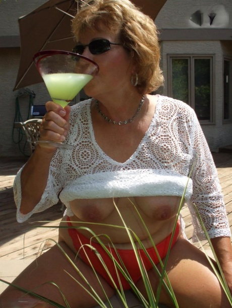 A picture of Busty Bliss, a mature woman with breast development, is taken after she consumes alcohol and shows her breast area.