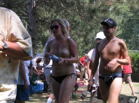 A group of amateurs are spotted undressing in different outfits at a clothing optional club.