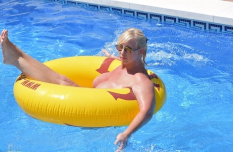 A swimming pool-bound Blonde amateur, Melody, shows off her fat body.