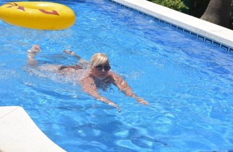 The overweight physique of Blonde amateurs like Melody is exhibited in front of a swimming pool.