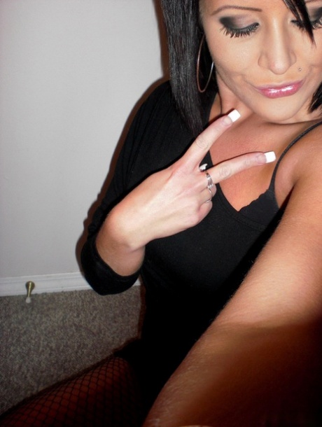 Teen amateur takes self shots while removing a little black dress in mesh hose