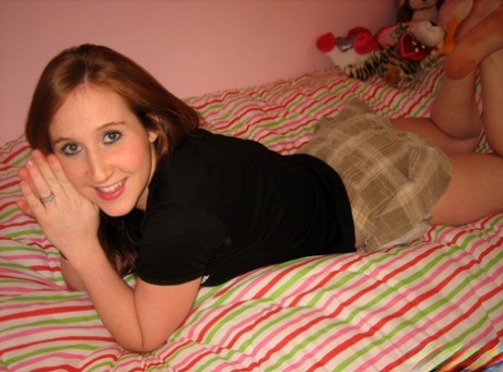 Young Redhead Gets Completely Naked While Alone On Her Bed