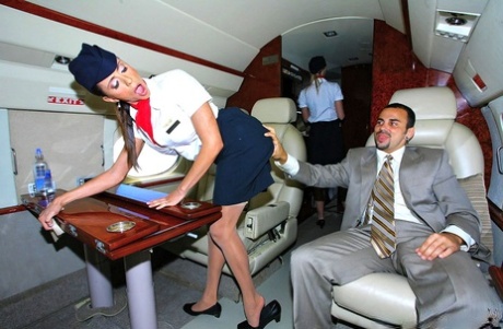 Clothed Stewardesses Seduce A Businessman For A Threesome Inside A Plane