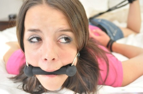 Among the tied and gagged Virgin, Kacey, is in the bedroom.